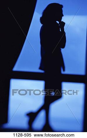 Stock Photography - woman, profile, staring, window, silhouette, standing, business. Fotosearch