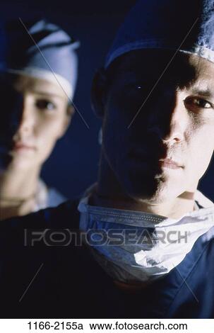 Stock Image - woman, surgery, masks, Middle-aged, serious, hospital. Fotosearch