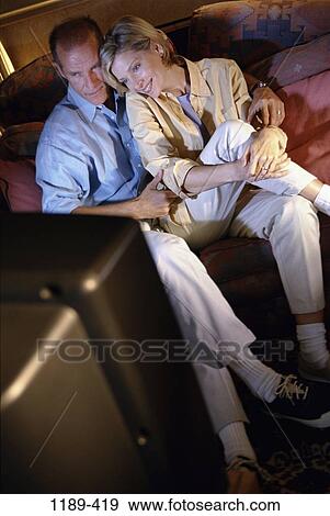 dark, people, home, smiling, couple, watch, couch View Large Photo Image Stock Photo - dark, people, home, smiling, couple, watch, couch. Fotosearch