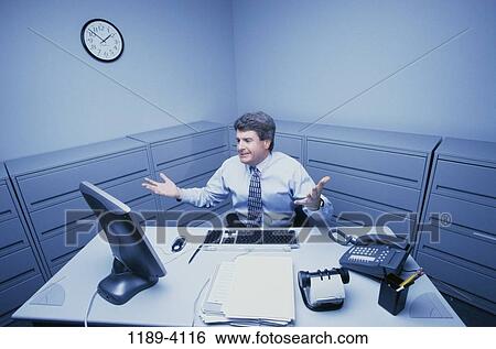Stock Photograph - desk, computer, business, Middle-aged, frustrated, confused. Fotosearch