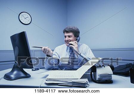 Stock Photo - desk, telephone, talking, conversation, computer, phone. Fotosearch