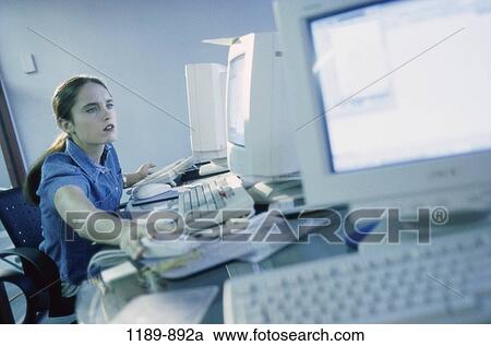 desk, woman, busy, business, computers, using, brunette View Large Photo Image Stock Image - desk, woman, busy, business, computers, using, brunette. Fotosearch