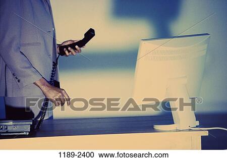 Stock Image - desk, woman, monitor, telephone, computer, phone, business. Fotosearch
