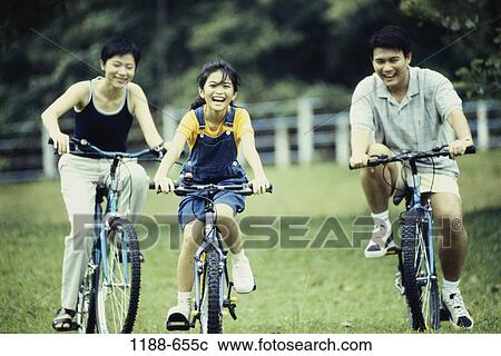 Field, people, Asian, laughing, riding, outdoors View Large Photo Image Stock Image - Field, people, Asian, laughing, riding, outdoors. Fotosearch