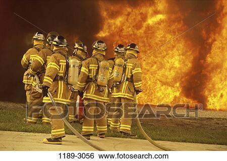 Stock Photograph - fire, industry, water, spraying, teamwork, spray, uniforms. Fotosearch