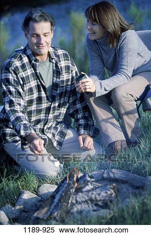 fire, people, relaxation, couple, outdoors, adventurous, Middle-aged View Large Photo Image Stock Photography - fire, people, relaxation, couple, outdoors, adventurous, Middle-aged. Fotosearch