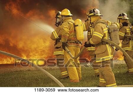 Stock Photo - fire, spraying, teamwork, uniform, helmets, spray. Fotosearch