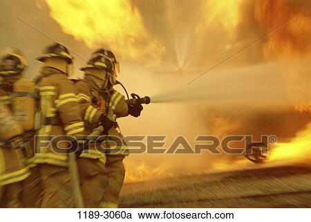Stock Image - fire, water, challenges, strength, confrontation, teamwork, helmets. Fotosearch