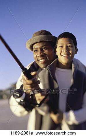 Stock Image - fish, people, beach, fishing, family, father. Fotosearch