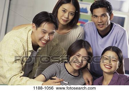Stock Photograph - group, people, pen, monitor, smiling, Asian. Fotosearch