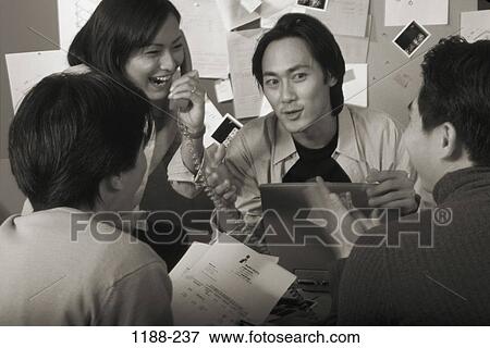 Stock Photo - group, telephone, discussion, Asian, computer, laptop, phone. Fotosearch