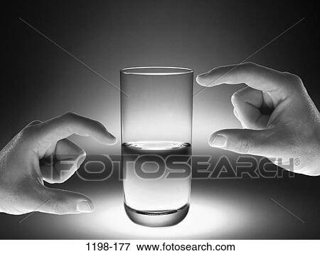 Stock Photo - hands, glass, half, water, choices, empty, measurement. Fotosearch