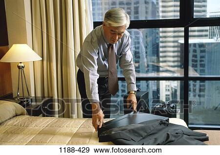Stock Photo - hotel, urban, briefcase, Asian, lamp, senior. Fotosearch