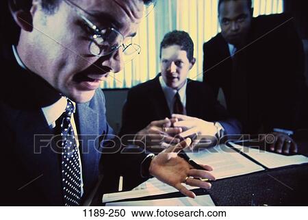 Stock Image - meeting, discussion, eyeglasses, planning, serious, businessmen, Caucasian. Fotosearch