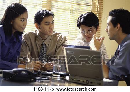Stock Image - meeting, group, Asian, eyeglasses, computer, laptop, conference. Fotosearch