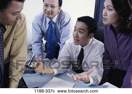 Stock Image - meeting, group, coworkers, talking, discussion, Asian, conversation. Fotosearch