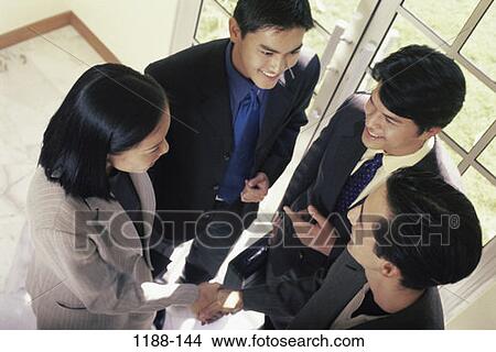 Picture - meeting, group, overhead, hands, smiling, Asian. Fotosearch