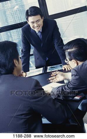 meeting, men, table, talking, Asian, gesturing, business View Large Photo Image Stock Photo - meeting, men, table, talking, Asian, gesturing, business. Fotosearch