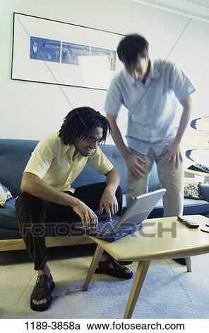 Stock Image - multiethnic, men, people, computer, laptop, indoors. Fotosearch