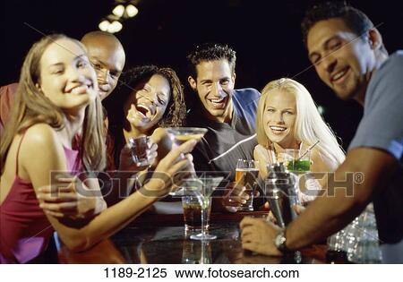 Stock Photography - multiethnic, people, beer, drinking, laughing, bar. Fotosearch