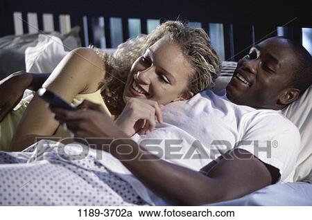 multiethnic, people, couple, bed, watch, watching, television View Large Photo Image Stock Image - multiethnic, people, couple, bed, watch, watching, television. Fotosearch