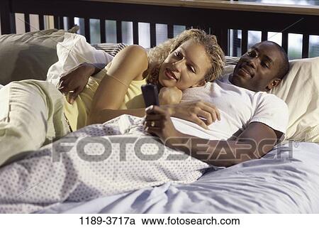multiethnic, people, couple, bed, watch, watching, television View Large Photo Image Stock Image - multiethnic, people, couple, bed, watch, watching, television. Fotosearch