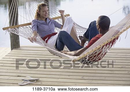 multiethnic, people, couple, hammock, outdoors, relaxing, relax View Large Photo Image Stock Image - multiethnic, people, couple, hammock, outdoors, relaxing, relax. Fotosearch