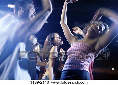 Stock Image - multiethnic, people, dancing, dance, joyous, friends, nightlife. Fotosearch