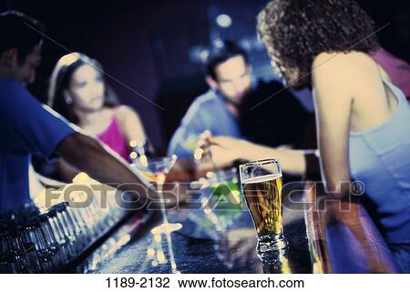 Stock Image - multiethnic, people, glass, glasses, beer, bar. Fotosearch