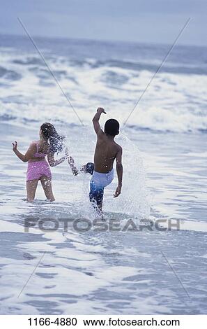 multiethnic, people, water, beach, splash, splashing, children View Large Photo Image Stock Image - multiethnic, people, water, beach, splash, splashing, children. Fotosearch