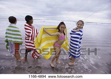 Picture - multiethnic, people, water, wrapped, beach, children. Fotosearch