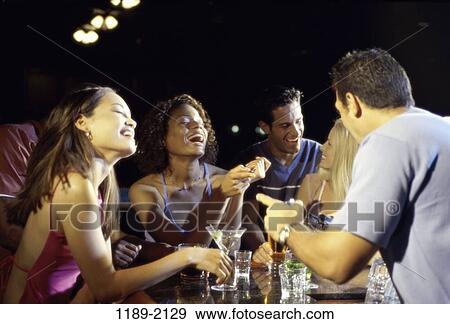 multiethnic, relaxed, drinking, happy, laughing, pointing View Large Photo Image Stock Photo - multiethnic, relaxed, drinking, happy, laughing, pointing. Fotosearch