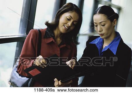multiethnic, women, coworkers, reading, book, pointing View Large Photo Image Stock Image - multiethnic, women, coworkers, reading, book, pointing. Fotosearch