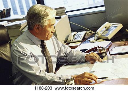 Stock Image - paperwork, Asian, senior, equipment, business, businessman. Fotosearch