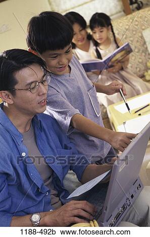 people, Asian, computer, reading, laptop, homework, pointing View Large Photo Image Stock Image - people, Asian, computer, reading, laptop, homework, pointing. Fotosearch