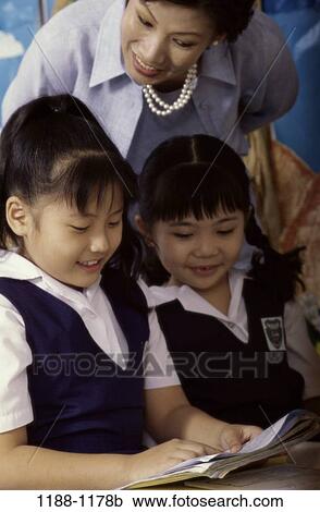 Stock Image - people, Asian, teacher, school, reading, children, education. Fotosearch