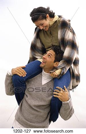people, balance, playing, couple, Hispanic, riding, playful View Large Photo Image Stock Photo - people, balance, playing, couple, Hispanic, riding, playful. Fotosearch