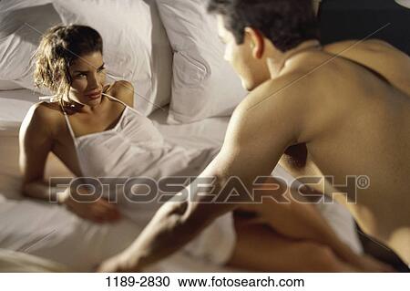 Stock Image - people, couple, bed, romance, brunette, indoors, Caucasian. Fotosearch