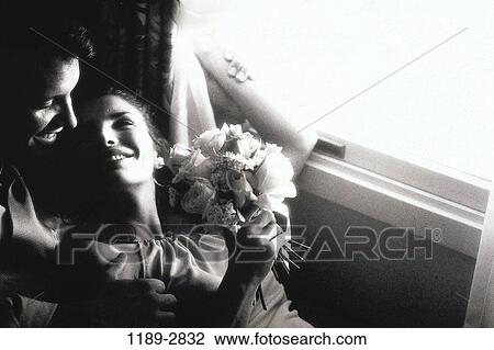 Stock Image - people, couple, flowers, romance, indoors, monochromatic, Caucasian. Fotosearch