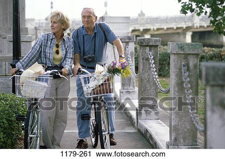 Stock Image - people, couple, senior, sunglasses, outdoors, adventurous, bicycles. Fotosearch