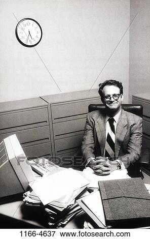 Stock Photo - people, desk, eyeglasses, business, individuality, Middle-aged, black and white. Fotosearch