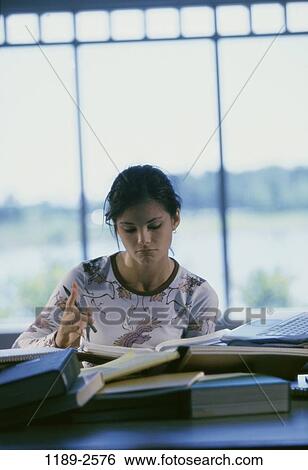 Stock Photograph - people, desk, table, books, computer, reading, laptop. Fotosearch