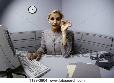 people, desk, woman, eyeglasses, computer, distorted View Large Photo Image Picture - people, desk, woman, eyeglasses, computer, distorted. Fotosearch