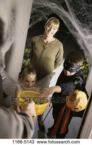 Stock Image - people, door, mother, candy, take, outdoors, costumes. Fotosearch