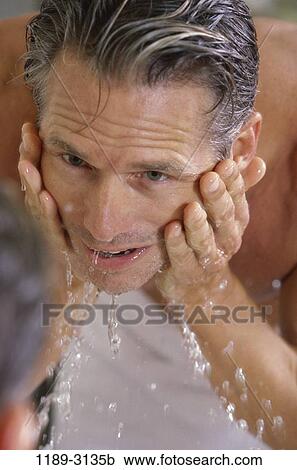 Stock Image - people, face, Middle-aged, washing, wash, indoors. Fotosearch