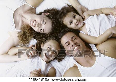 people, family, laying, daughters, parents, indoors View Large Photo Image Stock Image - people, family, laying, daughters, parents, indoors. Fotosearch