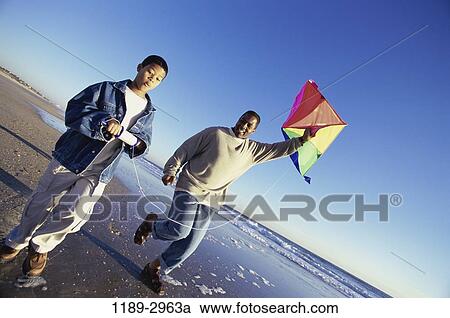 Stock Image - people, flying, beach, family, father, kite. Fotosearch