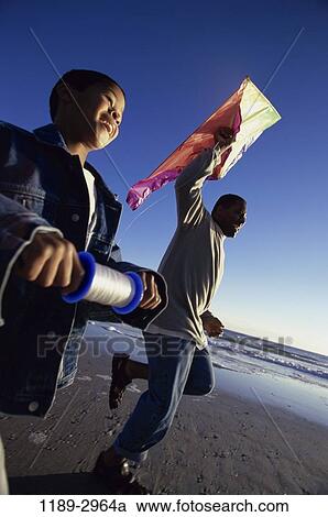 people, flying, beach, family, father, kite View Large Photo Image Stock Image - people, flying, beach, family, father, kite. Fotosearch