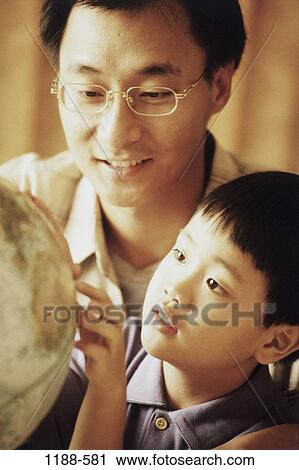 Stock Image - people, globe, Asian, eyeglasses, curious, family, learning. Fotosearch