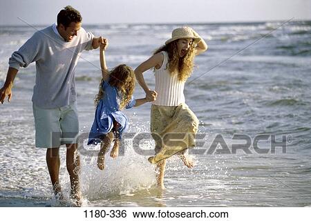 Stock Photograph - people, hat, beach, splash, splashing, joyous, commitment. Fotosearch